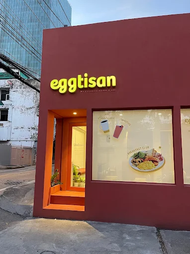 Eggtisan cafe exterior — charming coral-pink walls in Ari, Bangkok